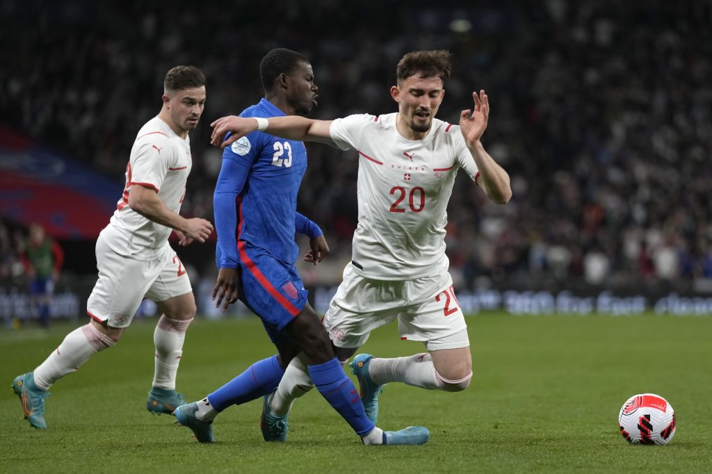 Switzerland's Andi Zeqiri, right, is challenged by England's Tyrick Mitchell during an international soccer match between England and Switzerland at Wembley Stadium in London, Saturday, March 26, 2022. (AP Photo/Alastair Grant)