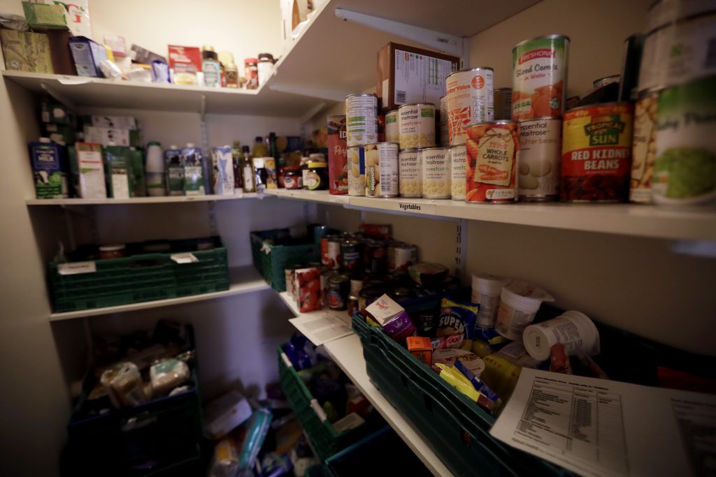 Tins of food stored in a cupboard at a foodbank in the Ivybridge estate community centre in west London.