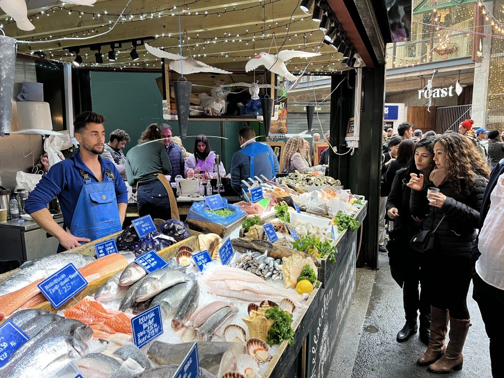People looking at fish stall in Borough Market 