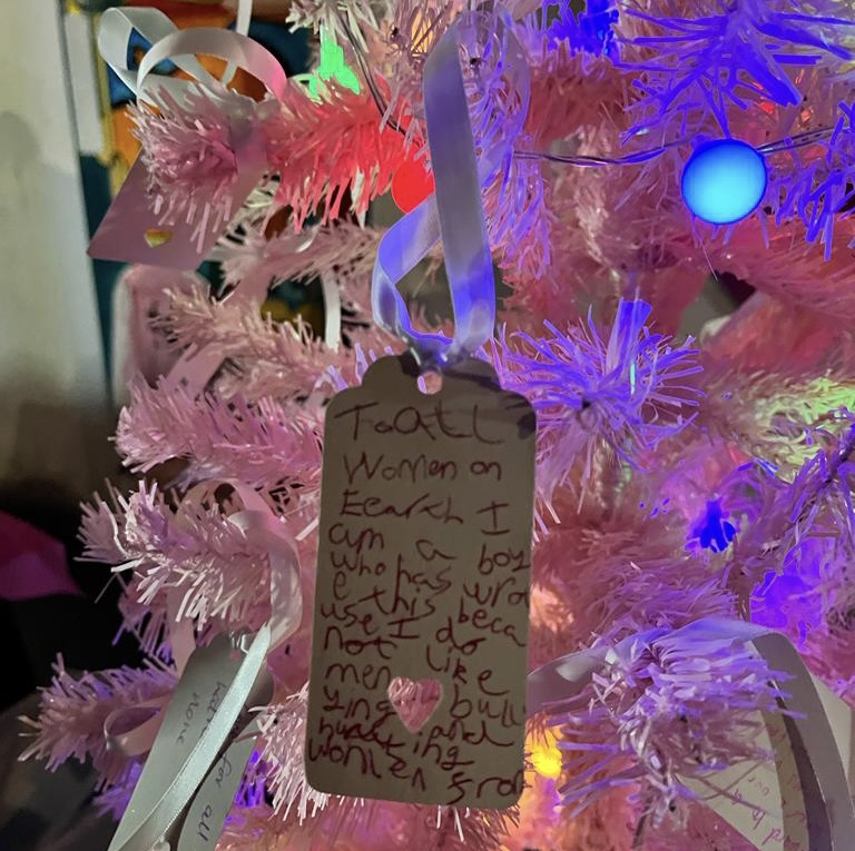 Christmas tree with a note hanging on it.